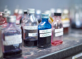 Chemical dye equipment and beakers in a fabric and industrial colouring cotton labratory factory. Dying fabrics for the fashion industry. Glass beakers and bottles.