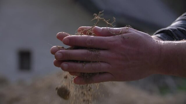 Two hands holding earth in hands, close to nature