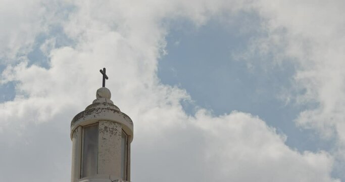 Cross at the top of Dominus Fleet Church - clouds moving