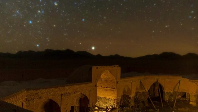 Rotating stars in a night sky over a historical landmark in Desert 
Ancient old traditional architecture design caravansary warm light on brick structure
Pavilion and porch ruins of heritage building