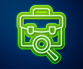 Glowing neon line Magnifying glass with briefcase icon isolated on blue background. Job hunting. Work search concept. Unemployment, head hunting, career. Vector