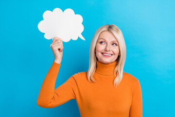 Portrait of lovely dreamy positive lady wear orange trendy clothes hold empty space weather...