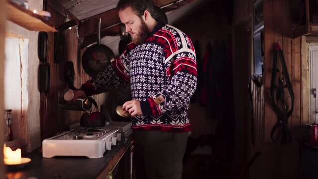 Norwegian Guy In A Kitchen Of A Winter Cabin. Medium Shot