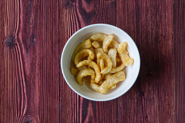 Pork Rinds on the Wood Table, Asian Crispy Side Dish for Eating With Noodle.