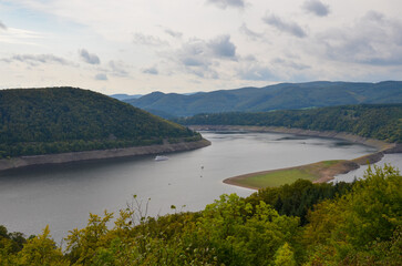 Fototapeta premium View of the mountain landscape at the Edersee with cloudy sky