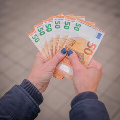 Woman holding euro notes in her hands