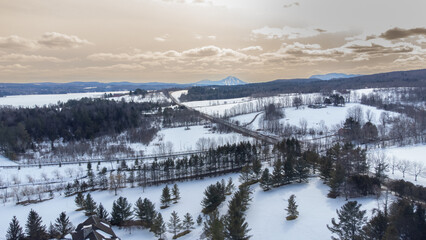 Flying over the cherry river in the Estrie region in winter in Quebec