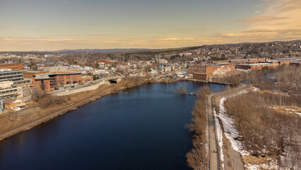 Fototapeta na wymiar Aerial view of part of the city of Magog in Quebec, Canada, with its river.
