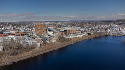 Fototapeta na wymiar Aerial view of part of the city of Magog in Quebec, Canada, with its river.