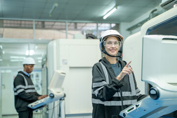 Engineer operating CNC computer machine working in industry factory.