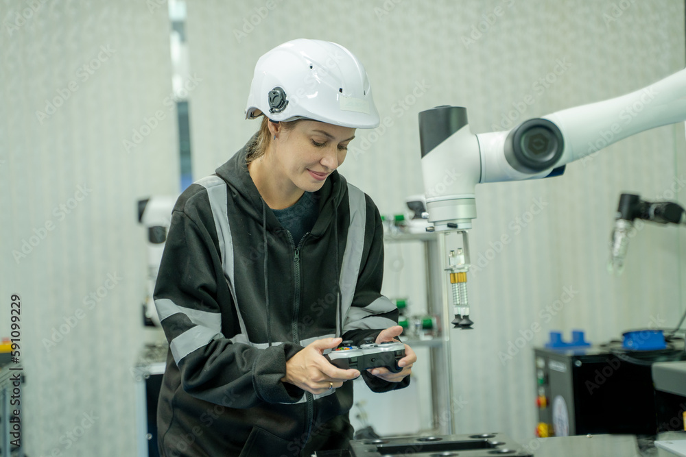 Fototapete engineer using laptop for programming modern robot arm in automated manufacturing industry,modern eq