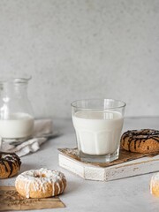 Vertical shot of milk and donuts