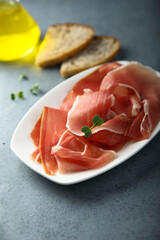 Delicious cured meat on a white plate 