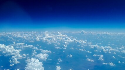 Aerial shot of the white fluffy clouds in blue sky on a sunny day
