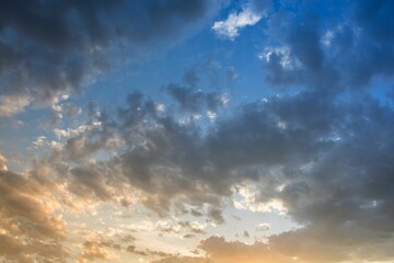 Naklejka na ściany i meble Dramatic shot of storm clouds illuminated by disappearing rays at sunset