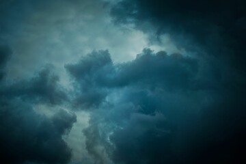 Fototapeta premium View of the sky with dark clouds in stormy weather before a thunderstorm, at the sunset