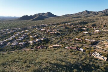 Drone shot of houses on hills in Arizona desert on a sunny day