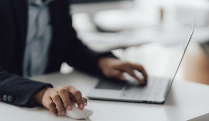 Happy working asian businessman talking on the phone with accounting documents at desk in happy working office