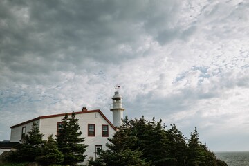 Lobster Cove Head Lighthouse under the densely clouds in Newfoundland, Canada