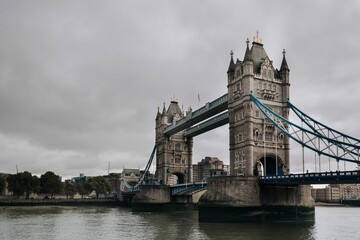 Fototapeta na wymiar Low angle shot of the Tower Bridge in London over the River Thames in cloudy weather