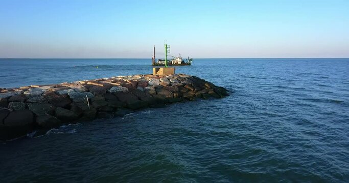 Ship to suck up the sand near a dike