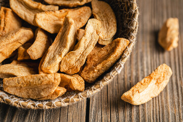 Homemade dried organic apple sliced on wood background.