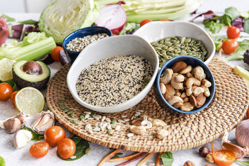Close-up, a bowl of chia seeds and other healthy foods on the kitchen table.