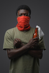 Studio shot of rebel man of african ethnic posing with crossed arms.