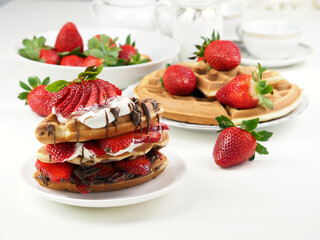 Breakfast with Viennese waffles, fresh strawberries and creamy chocolate sauce
