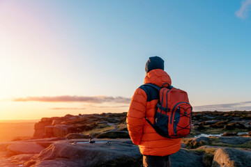 Bearded Man reaching the destination and on the top of mountain at sunrise or sunset on cold  day Travel Lifestyle concept The national park Pick District in England