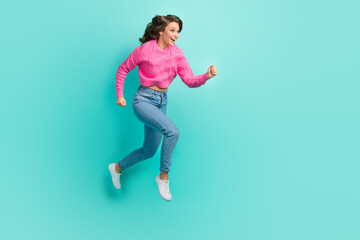 Fototapeta na wymiar Full length photo of adorable excited lady dressed knitted pullover running fast jumping empty space isolated teal color background