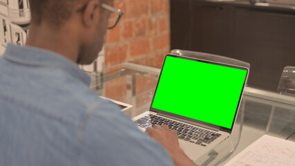 African Man Using Laptop with Green Screen