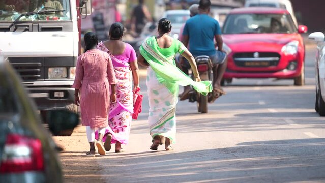 Indian street style outfit. Women wear traditional ethnic sari dress. Rural lady walk road way. Native hindu go village. National saree clothes. Folk suit robe. Local people live poor india country.