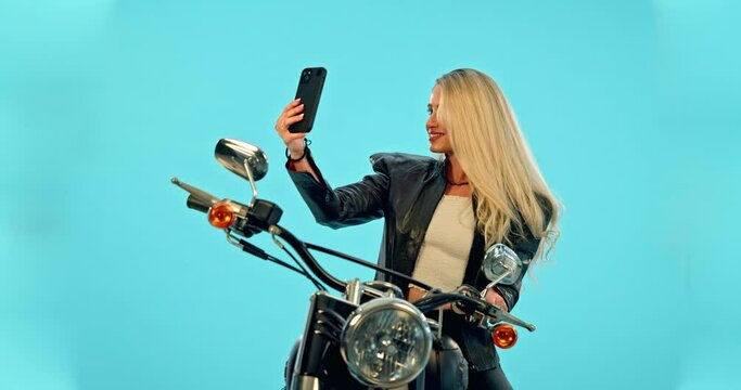 Selfie, blue background or woman on motorcycle with smile for travel adventure, road trip or holiday mockup. Motorbike, transport or happy girl taking picture for social media, post or studio memory