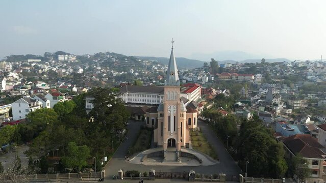 Drone footage in Dalat around the Cathedral St Nicholas. The "city of eternal springs" offer unique expericence to travellers in Vietnam. Camera is moving foward the church 1-2