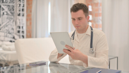Male Doctor using Tablet in Clinic