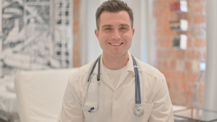 Portrait of Smiling Male Doctor in Clinic