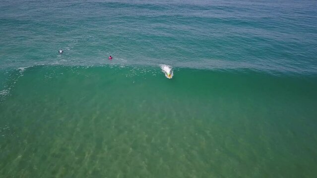 Bodyboarder paddles into position and catches epic long ride, rollo trick