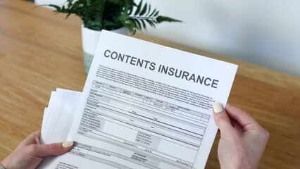 A woman opening a Contents Insurance Document letter outlining her policy and cover details