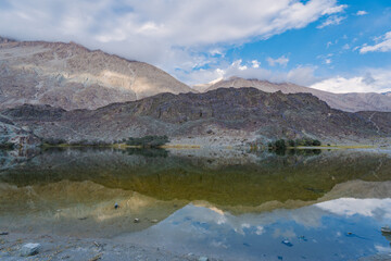 mountains, clouds and sky are  reflected on the lake. Beautiful scenery at Yarab Tso valley - Leh Ladakh - India