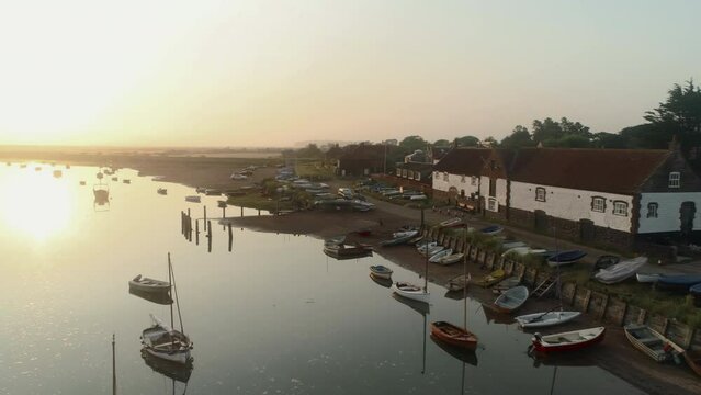 Establishing Aerial Drone Shot of Burnham Overy Staithe Coastal Village over Creek at Beautiful Sunrise in North Norfolk UK East Coast
