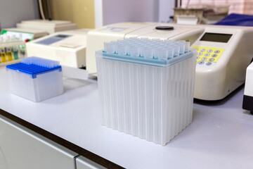 disposable plastic test tubes in the stand on the chemical laboratory table