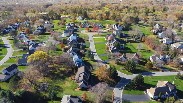 Cul-de-sac street in an established neighborhood with low density housing design and colorful autumn leaves in suburban Rochester, Upstate New York, USA