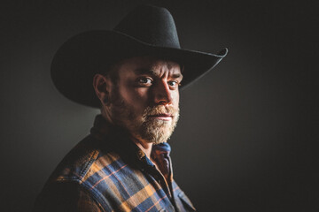 Rugged man in cowboy hat.  Studio session.