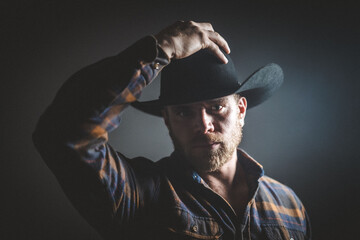 Rugged man in cowboy hat.  Studio session.