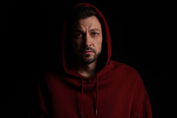 Obraz premium Portrait of sad man on black background