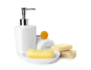 Soap bars, dispenser and terry towel on white background