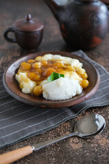 bubur sumsum is Indonesian traditional sweet dessert made by cooking rice flour in coconut milk and served with palm sugar. There is also a variety served with potato dumpling or biji salak.