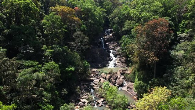 Beautiful waterfall in green forest, top view. Tropical in mountain jungle.