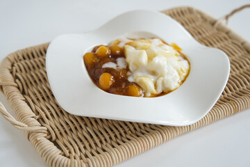 bubur sumsum is Indonesian traditional sweet dessert made by cooking rice flour in coconut milk and served with palm sugar. There is also a variety served with potato dumpling or biji salak.